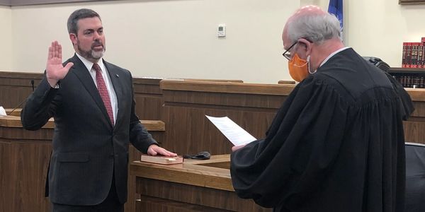 David being sworn in during a court ceremony.