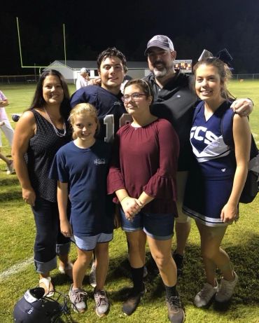 David and his family at a football field.
